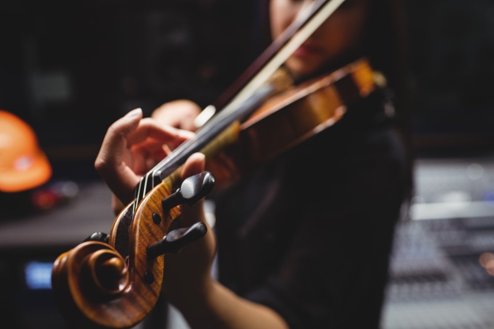 A violinist playing a piano