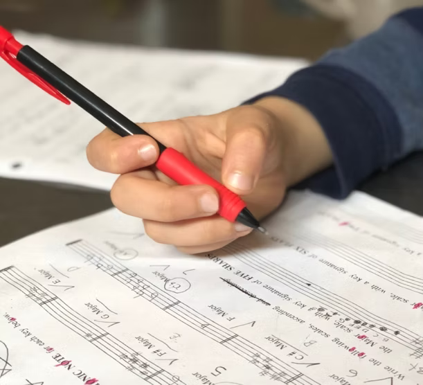 A person learning music theory and sheet music
