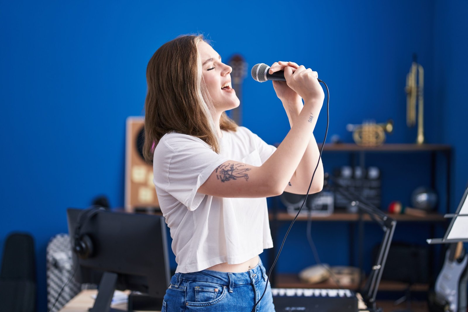 A woman singing while holding a microphone